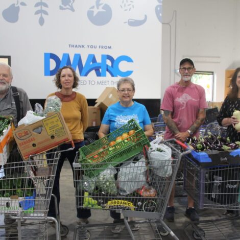 Highland Park Christian Church Community Garden poses with donated produce in the warehouse