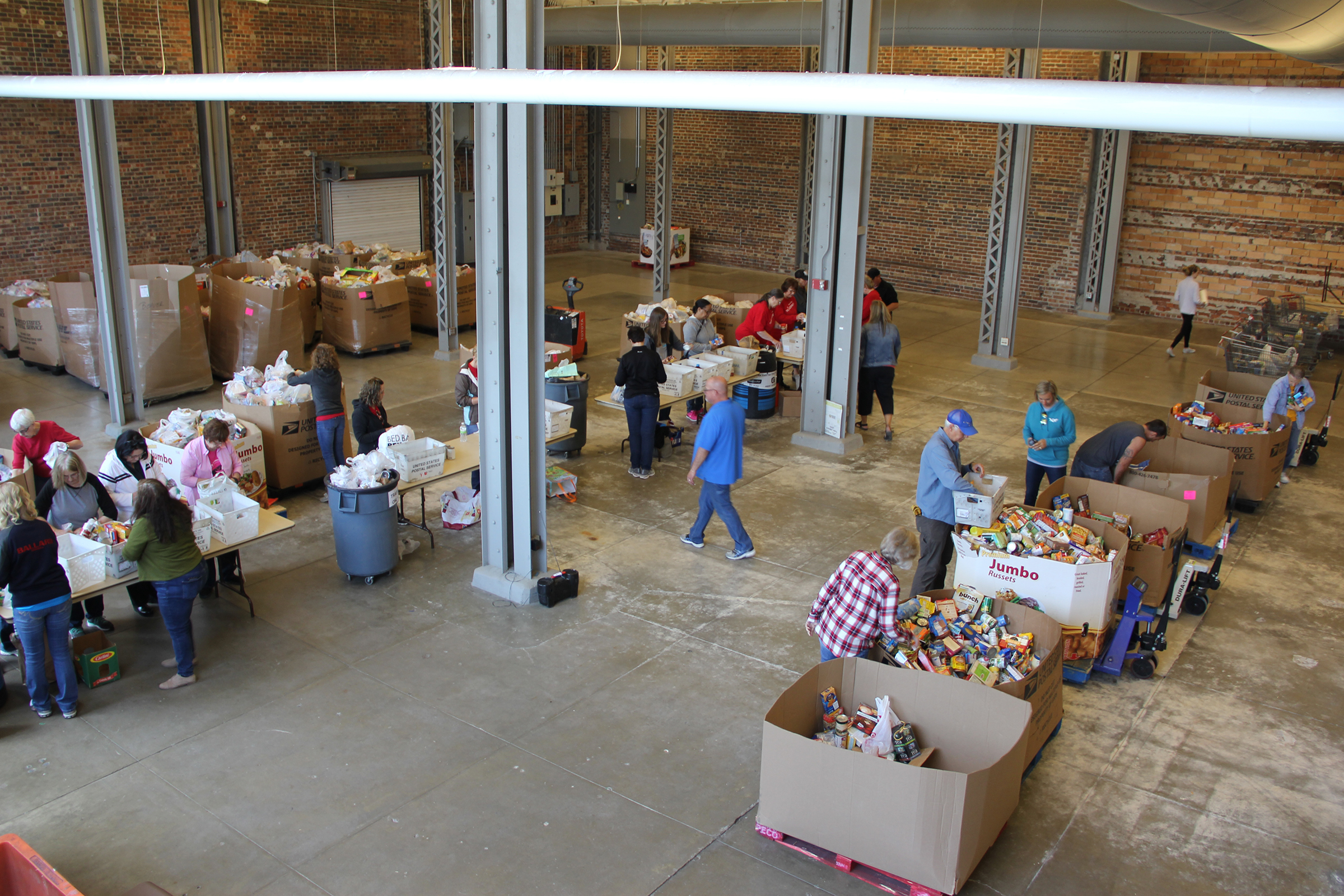 Overhead view of Stamp Out Hunger volunteers sorting food